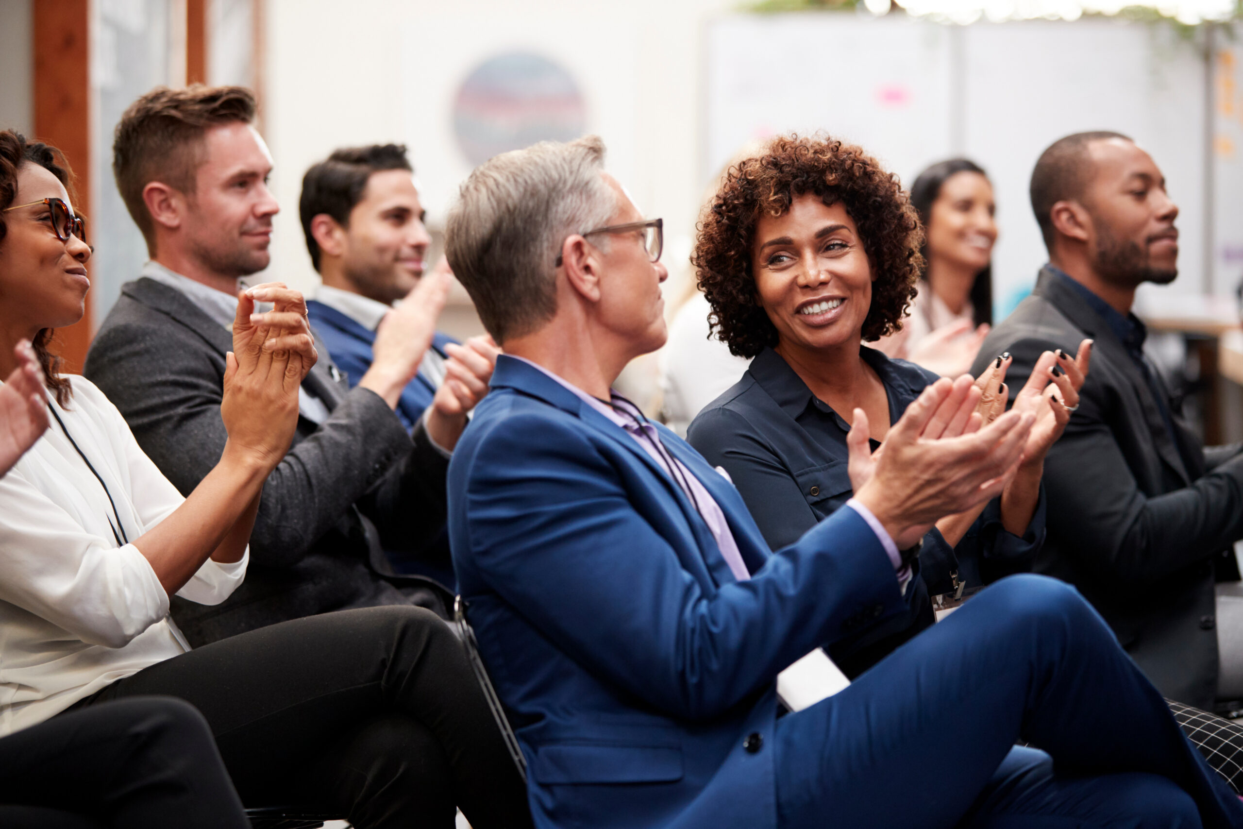 Audience applauding at a professional services conference